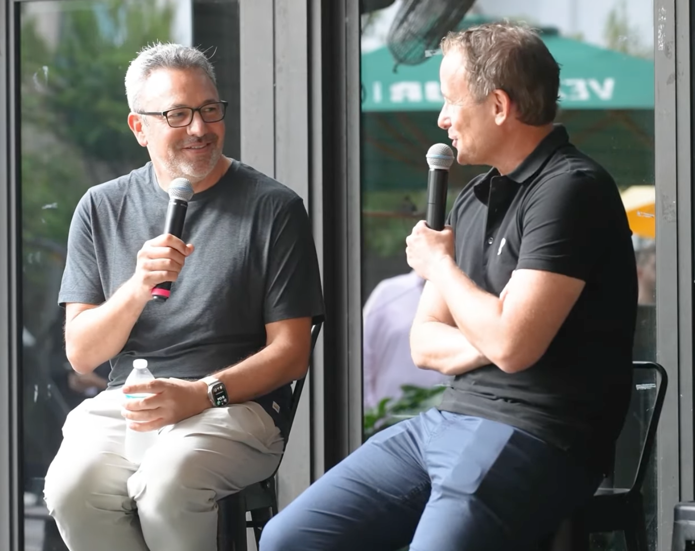 Adam Gross speaking at an event with a microphone